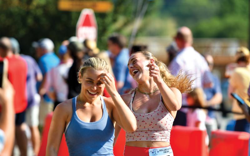 Wade Cheek/The Clayton Tribune. Clayton native Georgia Stockton (right) completes this year’s Lake Burton Fun Run with a smile.