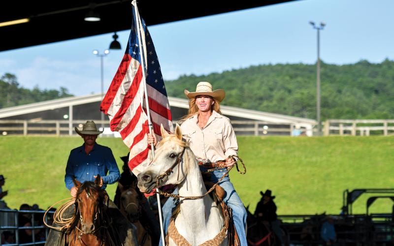 Wade Cheek/The Clayton Tribune. Mille Whitehead rides into the Rabun Arena with the American flag.