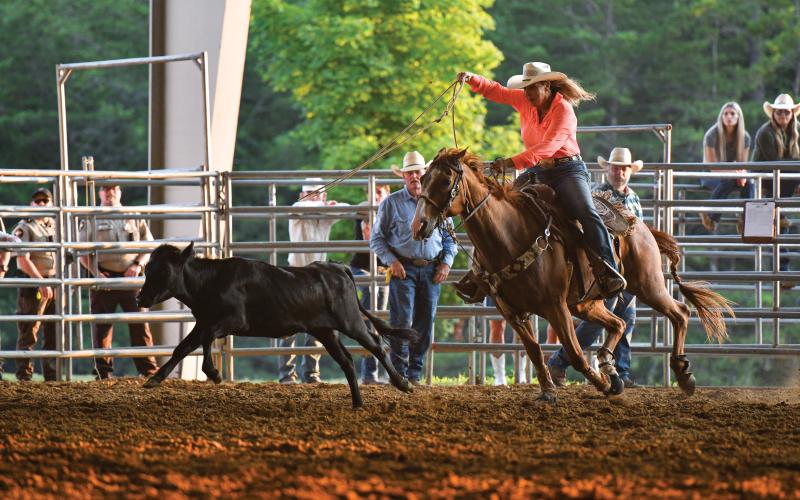 Wade Cheek/The Clayton Tribune. During the rodeo, Karla Dagenhart ropes a calf at the local arena.
