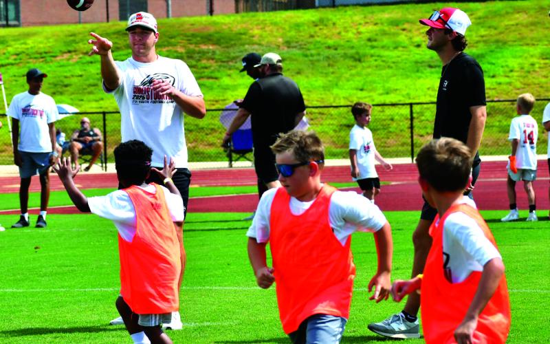 Enoch Autry/The Clayton Tribune. Georgia Bulldogs’ quarterback Gunner Stockton throws the football to youth at his Gunner Stockton Football Camp at Lakeview Academy in Gainesville, Ga., on July 20.