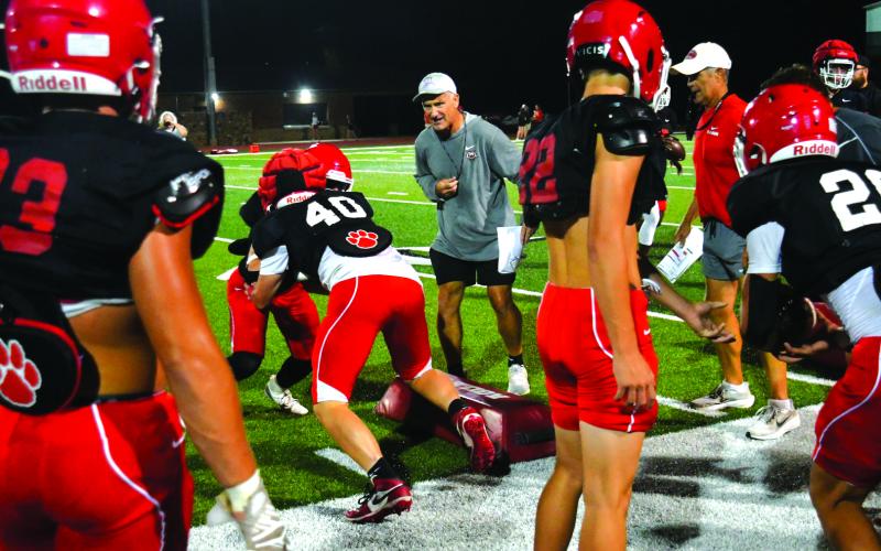 Enoch Autry/The Clayton Tribune. Rabun County coaches Bill Stewart and Rance Gillespie watch Wildcat players run a drill at the annual “Midnight Madness” on July 28.