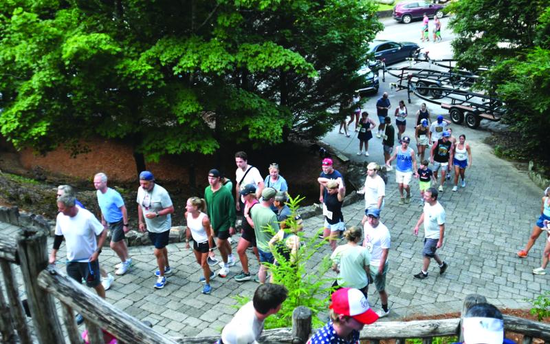 Enoch Autry/The Clayton Tribune. Rabun Ramble participants head up to the pavilion from the marina on Lake Rabun Road. Part of the net proceeds from the annual event go into the Lake Rabun Foundation.
