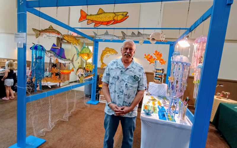 Megan Horn/The Clayton Tribune. David Oppenheimer is “Wild About Glass” as he displays his intricate creations, including this elaborate and colorful jellyfish hanging decoration, at last weekend’s Painted Fern Art Festival. Oppenheimer has been working with glass for 35 years.