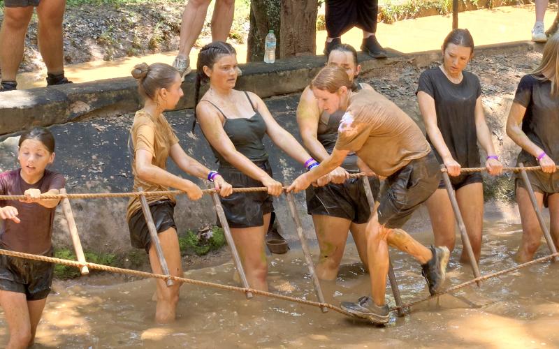 Submitted. Rabun County FFA girls assist Kris Dunsmore over the first obstacle of the Mud Course during the recent Summer Leadership Camp.