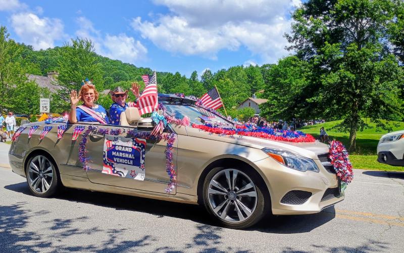 Megan Horn/The Clayton Tribune. The Grand Marshal in Sky Valley’s Grand Parade last weekend was Sally Shearon accompanied by her husband, George. Each year, Dee Vollmer drives the Grand Marshals in her decorated convertible while Dan Vollmer walks the parade dressed as Uncle Sam.