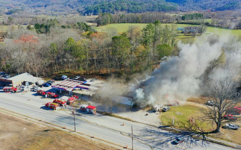 File photo/Photo courtesy of Drew Leviton. This aerial view captures gray smoke billowing from the Marathon station in Dillard on Dec. 7,2024, during a commercial structure fire. Firefighters worked to put out the commercial structure fire at the business known locally as the Dillard Quick Shop. After over seven months, the building has been demolished but the cause remains an “active and open investigation/case.”