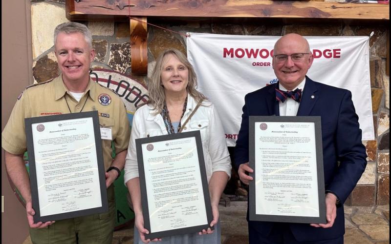 Submitted. The Georgia Tribe of Eastern Cherokee and the Executive Board of the Northeast Georgia Council, BSA, joined on June 26 to sign a Memorandum of Understanding that expressed these shared values and a commitment to support each other in increasing awareness and promoting authentic Cherokee heritage. Pictured are Trip Selman, Rhonda Bennett and Michael Levengood holding framed copies of the Memorandum of Understanding (MOU).
