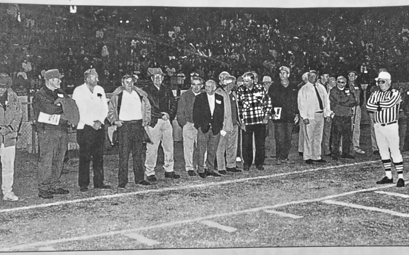 File photo/The Clayton Tribune. Members of the 1949 Rabun County football team served as honorary captains before the Oct. 23, 1998, Wildcat game on “Alumni Night.” The head coach of the first RCHS football team, Richard Burrell, passed away last at the age of 97. Burrell, a history teacher, also coached baseball and boys and girls basketball at RCHS.