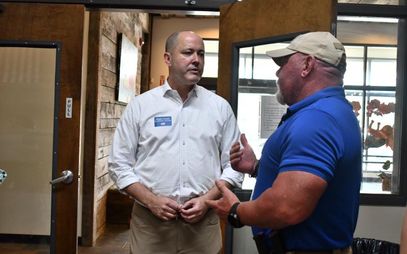 Megan Horn/The Clayton Tribune. Georgia gubernatorial Republican candidate Chris Carr speaks with Rabun County Sheriff Mark Gerrells during a Friday, Aug. 15, Meet-and-Greet at the Food Bank of Northeast Georgia.