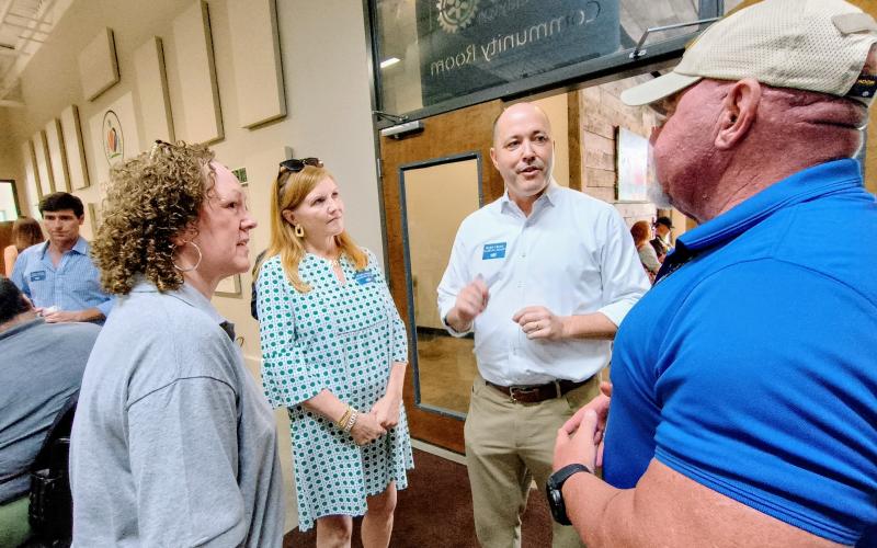 Megan Horn/The Clayton Tribune. Georgia gubernatorial Republican candidate Chris Carr, center, speaks with members of the community during a Friday, Aug. 15, Meet-and-Greet event. Pictured are Benita Cotton-Orr, left; Joan Carr (wife); Carr; and Rabun County Sheriff Mark Gerrells.
