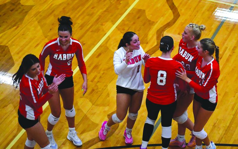 Enoch Autry/The Clayton Tribune. Rabun County Lady Cats volleyball celebrate after a solid play against visiting Flowery Branch on Aug. 5.