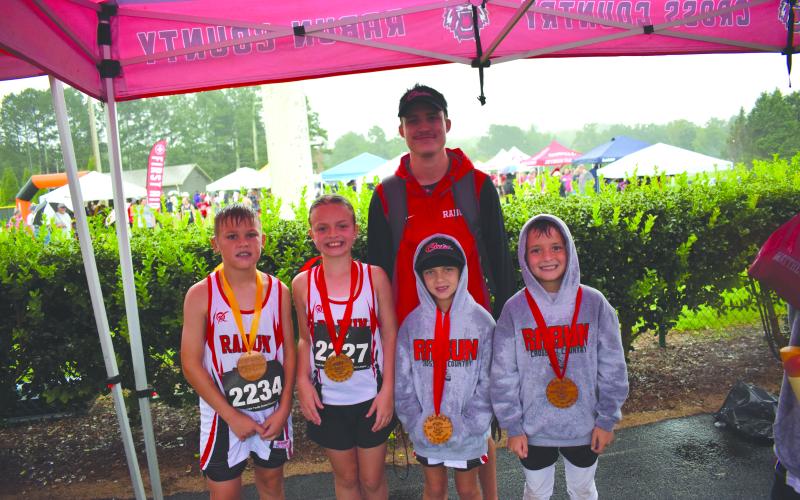 Submitted Photo. From left, top runners Keegan Hanifan-Wagner (10U), Harper Westbrook (10U), Nora Webb (8U), and Owen Moseley (10U) stand with Head Coach Ed Eidson at Athens Christian School on Aug. 23.
