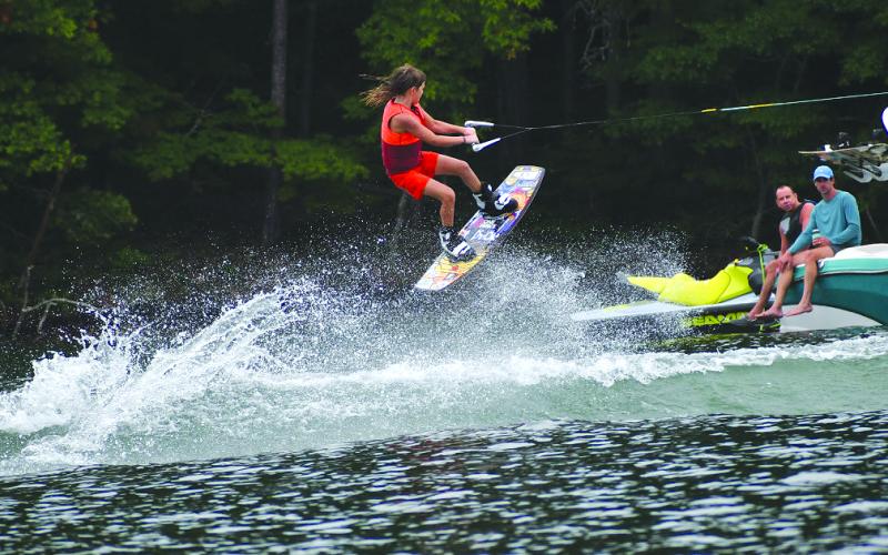Enoch Autry/The Clayton Tribune. Miller Stroble gets some air in the Beginner Division at the Mountain Air Classic on Aug. 2 on Lake Burton. Stroble took first place in the division as many watched from their boats.