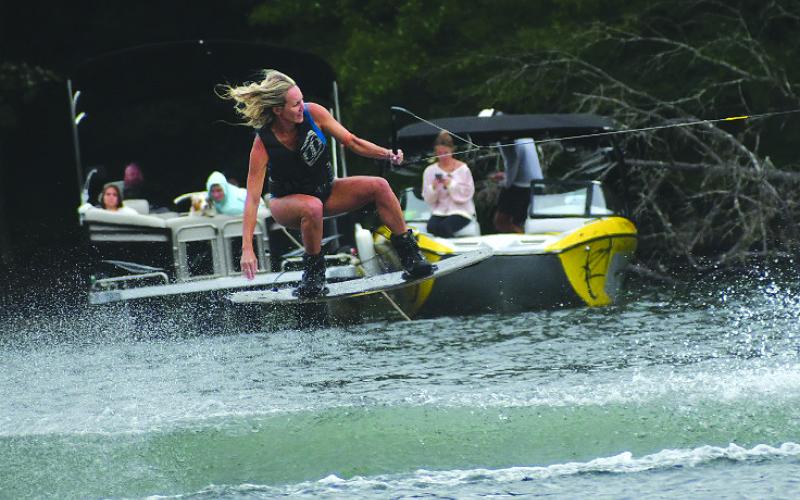 Enoch Autry/The Clayton Tribune. In front of onlookers in boats, Sarah Rhino glides through the air during the Mountain Air Classic on Aug. 2 to claim the Women’s Division. Rhino of Atlanta said her “home lake” is Lake Burton.