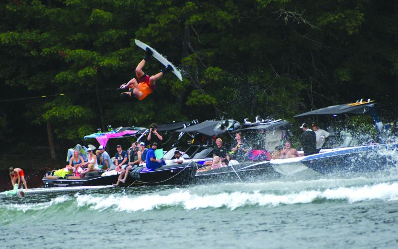 Enoch Autry/The Clayton Tribune. David Stroble, who finished third in the Advanced Division on Lake Burton at the Mountain Air Classic flies above the boaters on the lake.