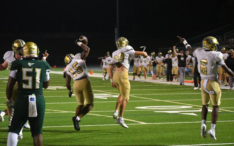 Wesley Branch/The Clayton Tribune. Rabun Gap's defense and sideline celebrate a forced turnover versus Grayson on Aug. 22