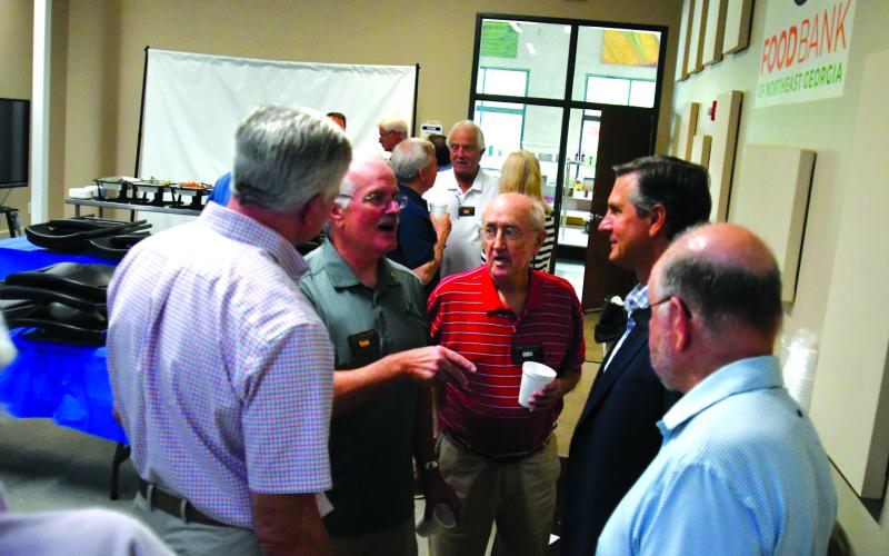 Enoch Autry/The Clayton Tribune. Standing with fellow Rotarians, Lee Penland (left) talks with Derek Dooley at the conclusion of the Rotary Club of Clayton’s June 19 meeting. Dooley, the club’s guest speaker, announced on Monday, Aug. 4, his intent to run as a Republican for U.S. Senate against Democratic incumbent Jon Ossoff. Dooley is a Clayton resident.
