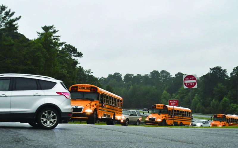 Enoch Autry/The Clayton Tribune. Rabun County buses and vehicles line up on an overcast morning for the first day of school on Monday, Aug. 4.