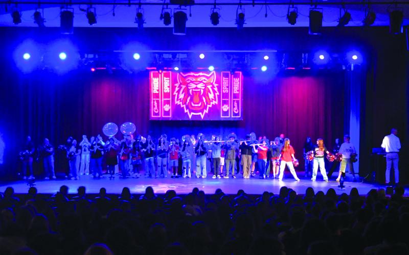 Enoch Autry/The Clayton Tribune.  The Rabun County Marching Wildcat Band performs for the RCHS student body on the first day of school on Monday, Aug. 4, inside the Fine Arts Building with pyrotechnics going off on the sides of the stage. This year’s band has grown in numbers up to 83.
