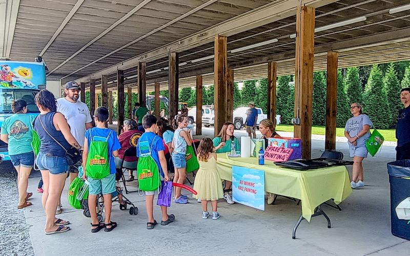Megan Horn/The Clayton Tribune. Kids were excited to have their face painted by local artist Ali Wilkins during the Saturday, Aug. 16, “Touch-A-Truck” event benefitting the nonprofit Rabun County Fuller Center for Housing. Over 250 children attended the event where they had the opportunity to  climb, “touch,” and explore many vehicles that represent our community heroes.