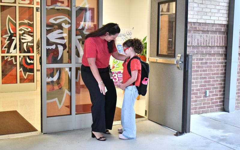 Megan Horn/The Clayton Tribune. Rabun County Primary School Principal Carla Truelove welcomes Shiloh Welborn, 8, on her first day of second grade Monday, Aug. 4.