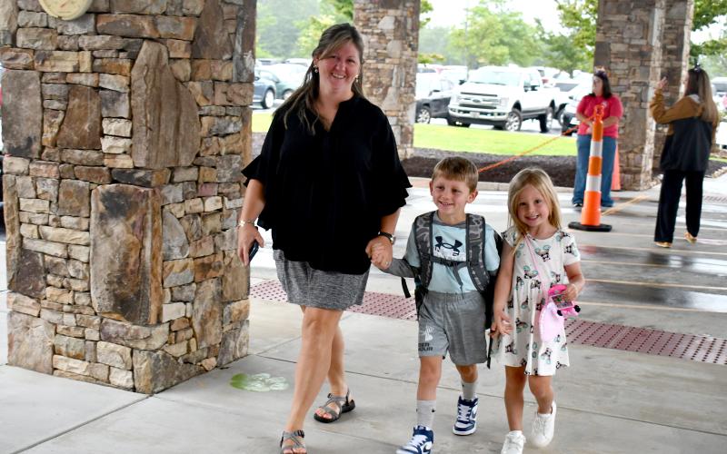 Megan Horn/The Clayton Tribune. Holly Aiken walks first grader Travis, 6, into Rabun County Primary School for the first day on Monday. Pre-k student Claire, 4, is excited to start class at the same school Thursday, Aug. 7.