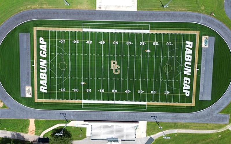 Submitted Photo.  An aerial view shows the newly installed Rabun Gap turf field that was bought through donations to the athletic program. BELOW RIGHT: The RGNS weight room has been expanded with new equipment.