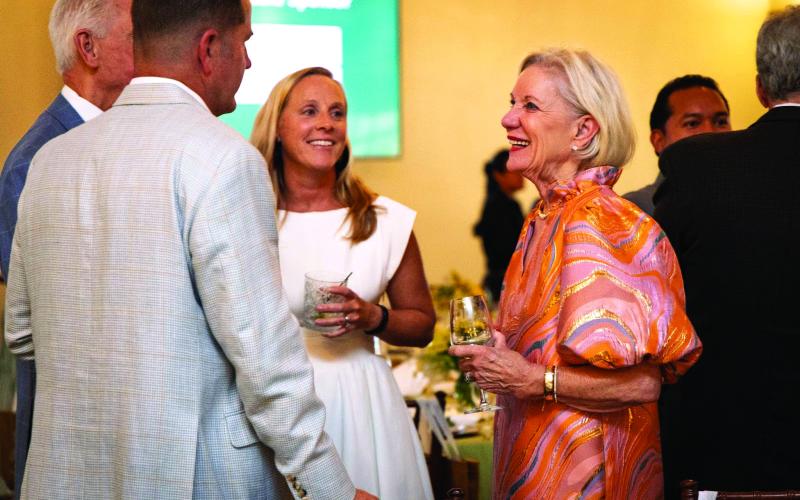 Submitted photo. Ben Weisser, Alan White, Bethany Weisser and Lynda White, all of Clayton, talk at the Rabun Gap-Nacoochee School’s Green &amp; Gold Gala at The Dillard House. The gala raised a record total in its third year.
