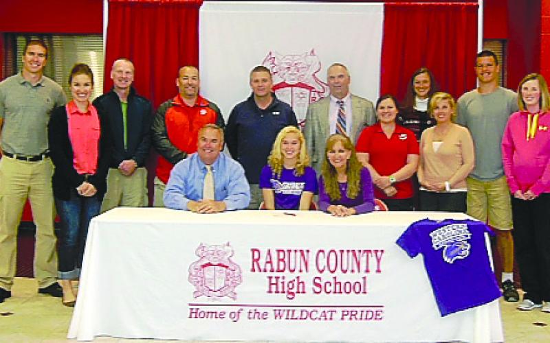 Submitted Photo. Rabun County’s Sally Woerner (seated, center) is surrounded by family and friends as she signs a national letter of intent to play at Western Carolina University.