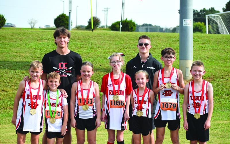 Submitted Photo. The Rabun County Recreation Department Cross Country had an incredible showing at Meet No. 3 at Lamar Murphy Park at Jefferson, Ga. The medalists included Keegan Hanifan-Wagner, Owen Moseley, Harper Westbrook, Madison Anderson, Opal Aker, Caiden Wood and Alden English. Also pictured are Assistant Coach CJ Augustine and Head Coach Ed Eidson. Not pictured is Nora Webb, who also medaled. Eidson said he is proud of this group for the hard work, grit, and pride they continue to show each week.