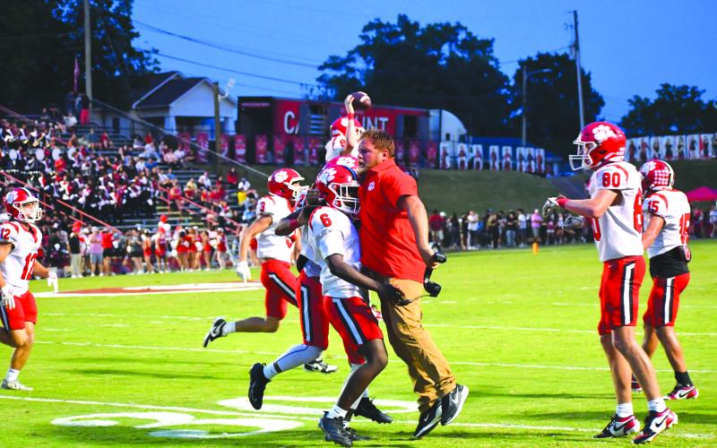 Wesley Branch/The Clayton Tribune. Rabun County assistant coach Ty Maxwell chest bumps JK Fruster after the Wildcats make a defensive stop to preserve a 49-42 road win over Dalton on Sept. 5.