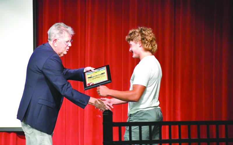 Wesley Branch/The Clayton Tribune. Georgia High School Football Daily marketing director Ted Langford shakes hands with Rabun County senior Reid Giles