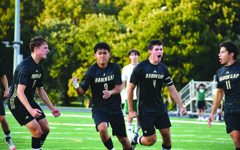 Wesley Branch/The Clayton Tribune. Rabun Gap junior Jose Luis Carrillo (No. 9, center) celebrates a goal with his teammates versus Christ School on Sept. 11. The game was canceled by the officials with 28 minutes remaining.