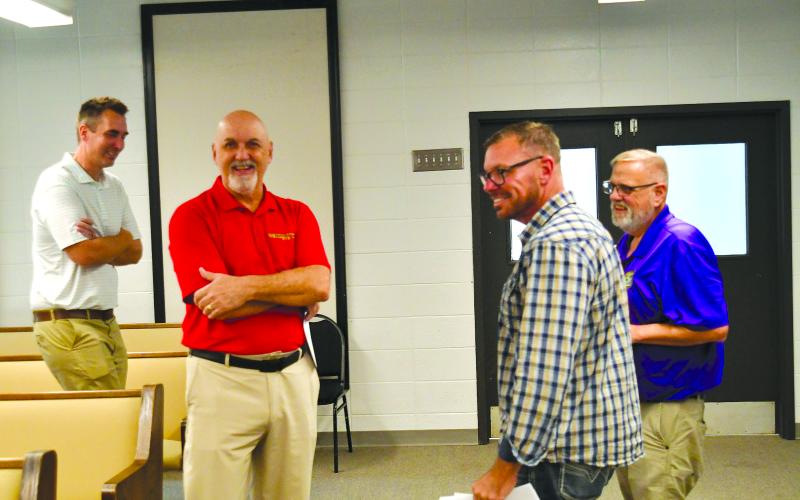 Enoch Autry/The Clayton Tribune. New Clayton mayor Roy Quilliams (center) shares a laugh with Mayor Pro Tem Stacy Fountain at the conclusion of the Clayton City Council meeting on Sept. 9. The council voted in favor of Quilliams filling the unexpired term of former mayor Kurt Cannon, who resigned in June.