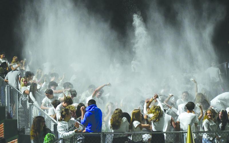 Enoch Autry/The Clayton Tribune. Rabun Gap-Nacoochee School students toss white power as the final seconds run off the clock as the Eagles claim a 42-0 win in the first home game of the season which was themed “White Out Night.”