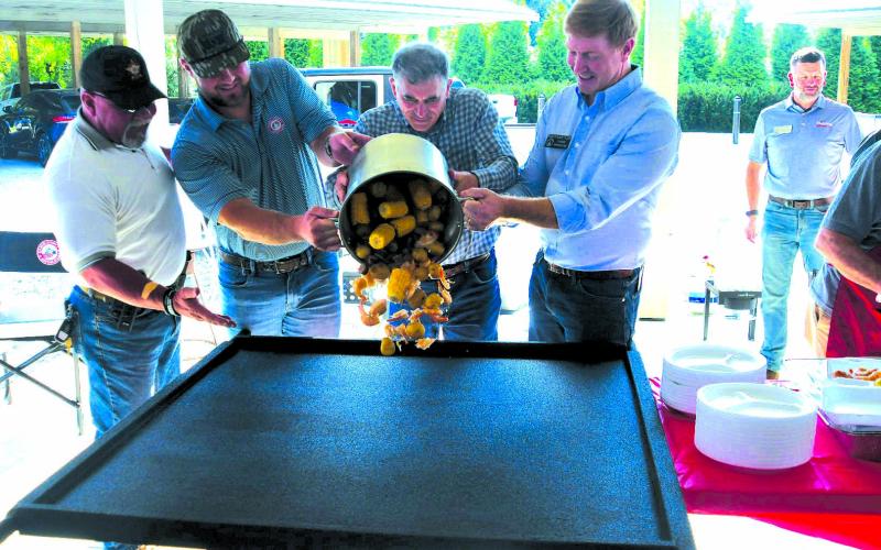 Enoch Autry/The Clayton Tribune. Rabun County Sheriff Mark Gerrills, State Sen. Bo Hatchett, U.S. Congressman Andrew Clyde and State Sen. Blake Tillery, who is running for lieutenant governor pour a pot of low country boil onto a table for the Sept. 13 meal to begin at the Civic Center Pavilions at 201 West Savannah St., Clayton. Republicans seeking seats in the 2026 election spoke to the 9th District gathering on Saturday evening.