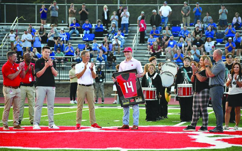 Enoch Autry/The Clayton Tribune. Gunner Stockton holds his newly retired No. 14 Rabun County Wildcat jersey during a Sept. 19 pregame ceremony at midfield of Frank Snyder Memorial Stadium. The standout former RCHS quarterback, who still owns Georgia state football records, now is the starting QB for the University of Georgia.