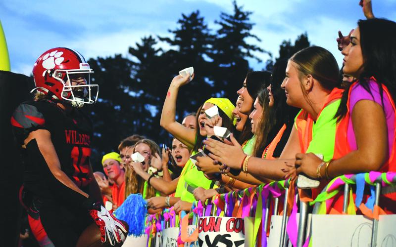 Enoch Autry/The Clayton Tribune. Rabun County senior Reid Giles celebrates in the end zone with RCHS students after a touchdown versus Banks County on Sept. 19.