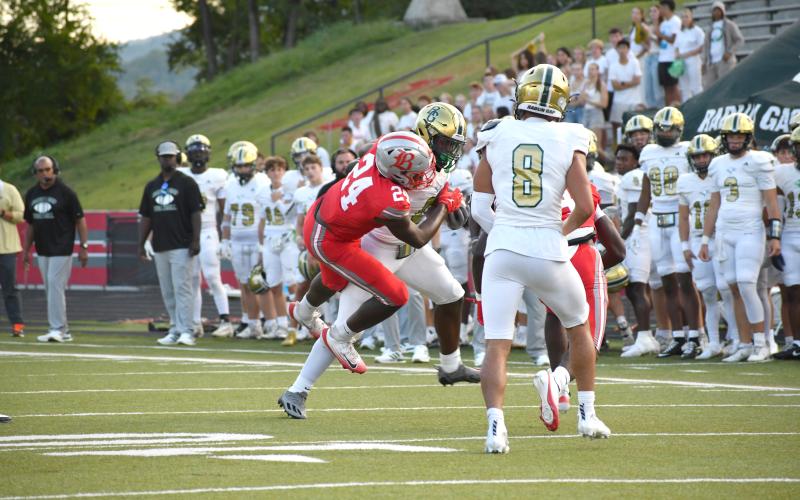 Wesley Branch/The Clayton Tribune. Rabun Gap running back Royce Djouguem stiff arms a Baylor defender in the Eagles’ loss.