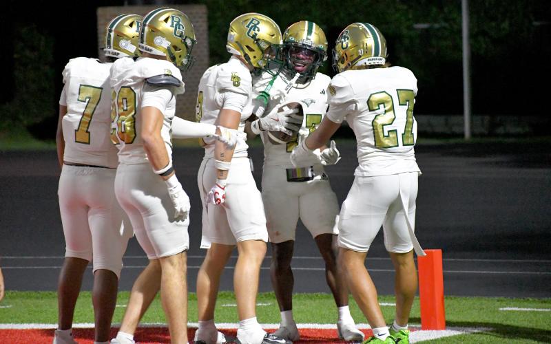 Wesley Branch/The Clayton Tribune. Rabun Gap players swarm teammate Joshua Buckhalter in celebration after Buckhalter’s punt return for a touchdown against Baylor on Aug. 29. The visiting Eagles would fall to the Red Raiders 35-34.