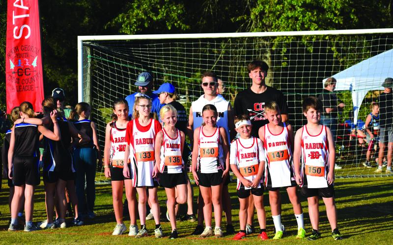 Submitted Photo. Rabun County Recreation Department cross country head coach Ed Eidson and assistant coach CJ Augustine pose for a photo with the 10U teams before the start of the race in Madison on Sept. 13.