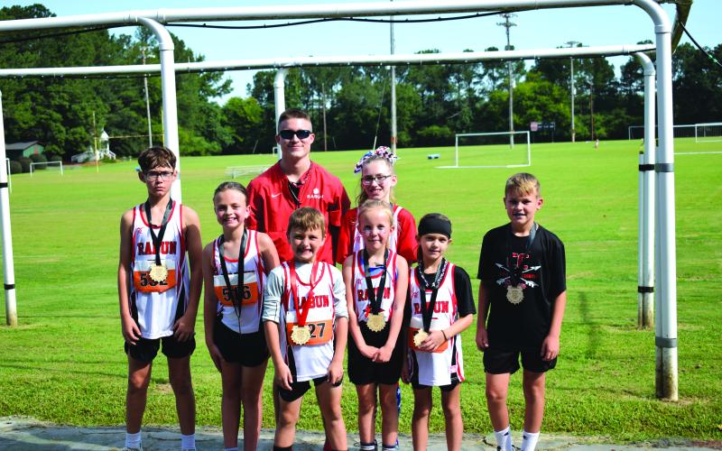 Submitted Photo. Top 10 finishers pictured along with Head Coach Ed Eidson, include Caiden Wood, Harper Westbrook, Owen Moseley, Madison Anderson, Opal Aker, Nora Webb, and Keegan Hanifan-Wagner.