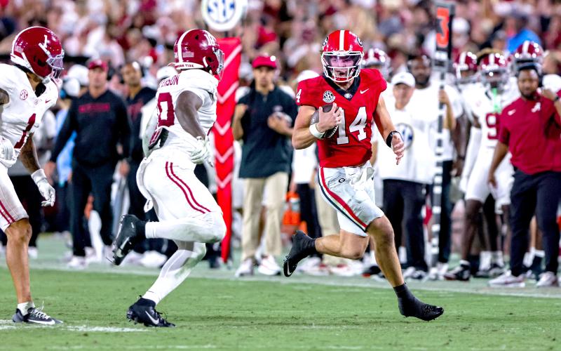 Photo/Conor Dillon/UGAAA. Current Georgia and former Rabun County quarterback Gunner Stockton runs versus Alabama in the Bulldogs’ 24-21 loss to the Crimson Tide. Stockton threw for 130 yards and a touchdown in the game and ran for 22 yards. UGA plays Kentucky at home on Saturday.