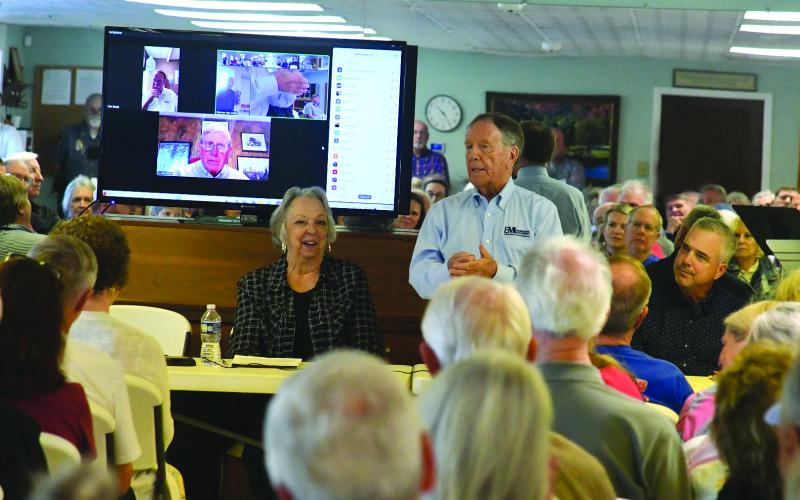Enoch Autry/The Clayton Tribune. With Sky Valley Mayor Hollie Steil sitting next to him, Jerry Hood, chief executive officer for EMI Engineering Management, talks to the crowd.