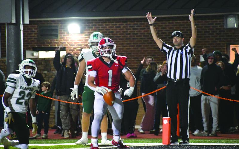 Enoch Autry/The Clayton Tribune.After fighting through the tackle attempt by Athens Academy’s Keyon Standifer (23), senior Wildcat running back Lake Evans celebrates in the end after his second touchdown run of the night.