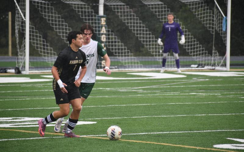 Wesley Branch/The Clayton Tribune. Rabun Gap’s Manuel Uribe dribbles through Christ School defenders in the Eagles’ match versus the Greenies on Sept. 30. The game was rescheduled after the original match was canceled with 28 minutes remaining.