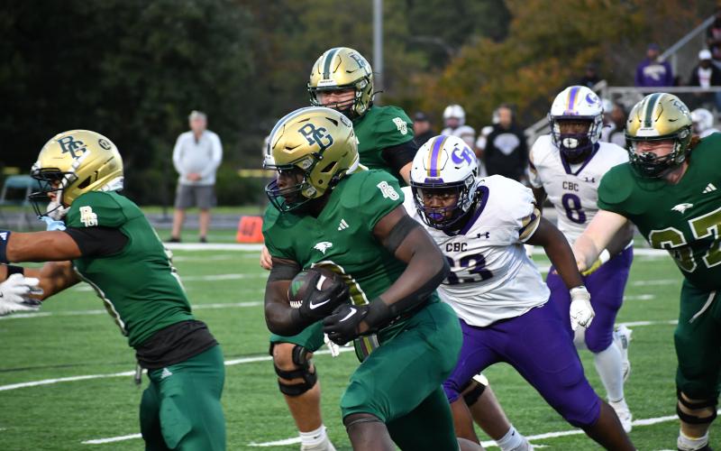 Wesley Branch/The Clayton Tribune. RGNS sophomore running back Royce Djouguem runs through CBC’s defense in the Eagles’ 59-49 loss to the Cadets on Oct. 3. Djouguem ended the game with 48 total yards, 40 of which came on the ground.
