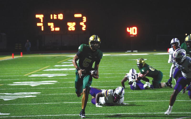 Wesley Branch/The Clayton Tribune. Rabun Gap senior quarterback Gavin Owens runs for a 26-yard touchdown versus Christian Brothers College on Oct. 3. Owens led the Eagles in rushing with 55 yards and threw for 330 yards in the loss.