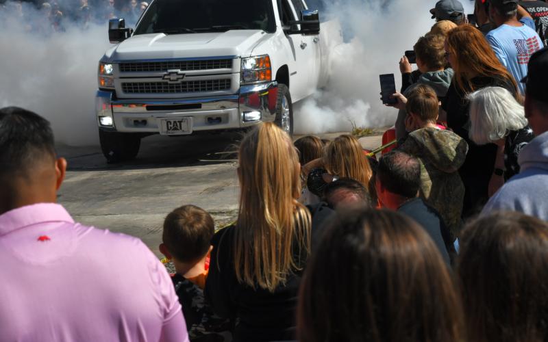 Enoch Autry/The Clayton Tribune. A Chevy pickup stirs up some smoke during the burnout contest as the crowd watches closely.