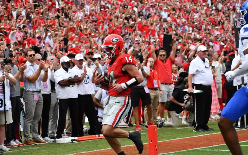 Wesley Branch/The Clayton Tribune. Georgia quarterback Gunner Stockton takes it into the end zone against Kentucky a touchdown run in the Bulldogs’ 35-14 win over Kentucky on Oct. 4. Former Rabun County standout whose high school No. 14 jersey has been retired, Stockton finished with three total touchdowns for UGA, including two rushing.